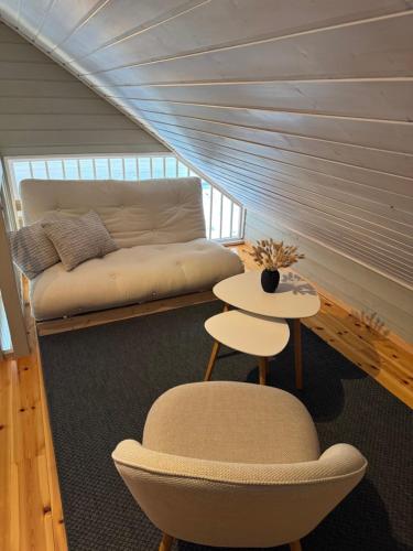 a room with a bed and a chair and a table at Charming house located by the fjord with the Pultpitrock within short distance in Strand