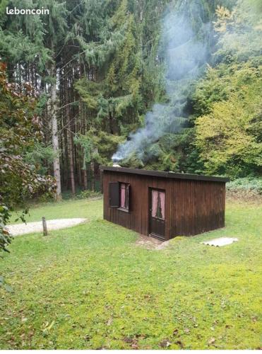 a small cabin with smoke coming out of its windows at grangeon des milles et une nuit in Cerdon