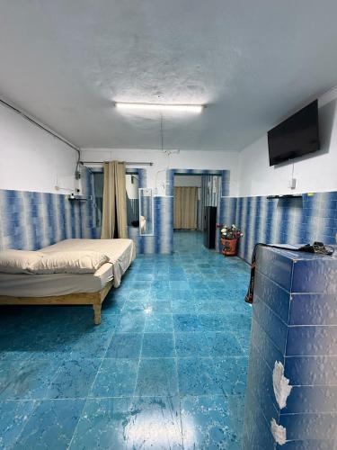 a room with two beds and a flat screen tv at CasaAZUL in Progreso