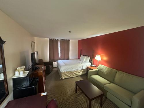 a hotel room with a bed and a couch at Econo Lodge City Centre in Kingston