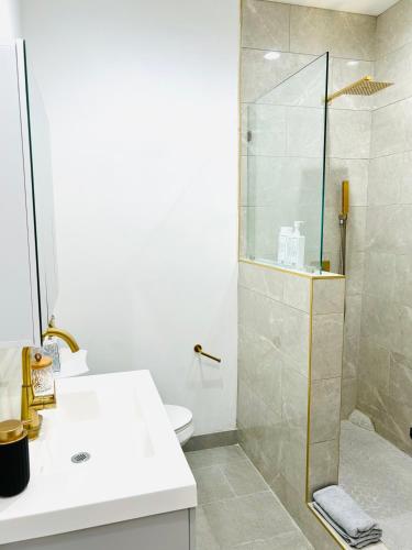 a bathroom with a shower and a toilet and a sink at New Lux Skyline Loft in LA in North Sherman Way
