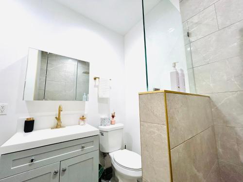 a bathroom with a sink and a toilet and a shower at New Lux Skyline Loft in LA in North Sherman Way