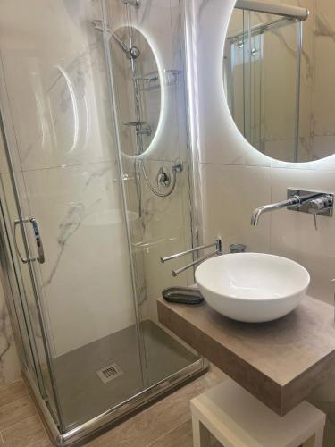 a bathroom with a sink and a shower at Slow Chic Apartment Papardo in Messina