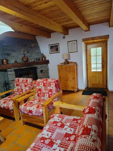 a living room with two chairs and a fireplace at La Baita di Savara - nature and silence in Valsavarenche