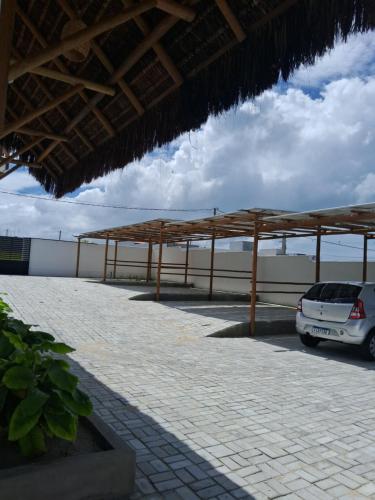 a car parked in a parking lot next to the ocean at Lighthouse Pipa in Tibau do Sul