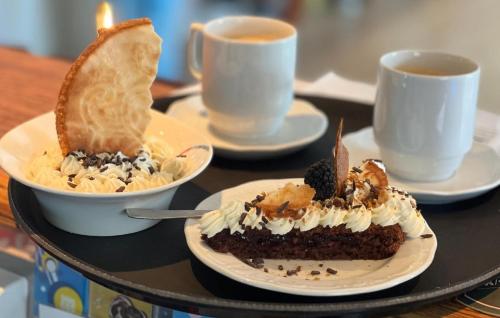a table with two plates of food and two cups of coffee at Hohenwarte in Højer