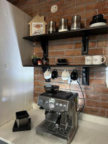 a kitchen with a espresso machine on a counter at Mario & Luiza's Place - Cozy Stay with Pool & Braai in Worcester