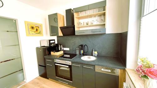 a small kitchen with a sink and a stove at 2 ZKB-3OG oder 3 ZKB-UG im Zentrum zw Rathaus und Dom in Augsburg