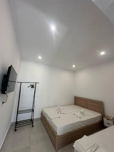 a room with a bed and a television in it at Deluxe apartment by the sea in Skála Foúrkas