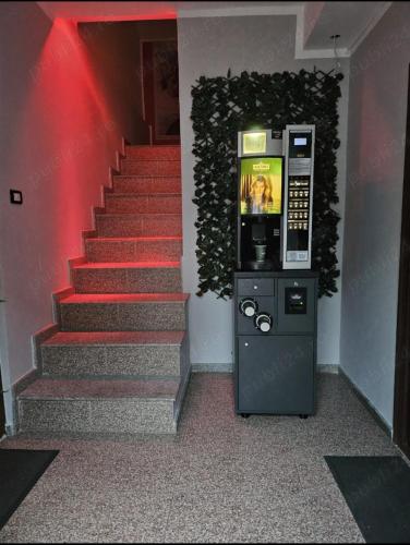 a stairway with a vending machine next to a staircase at Rasfat in Focşani
