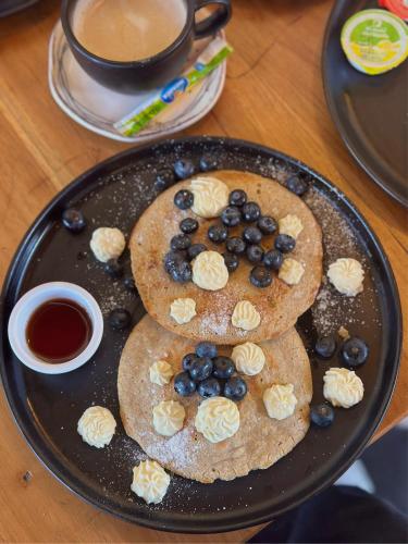 a plate of pancakes with bananas and blueberries on it at Hotel La Magdalena in Cartagena de Indias