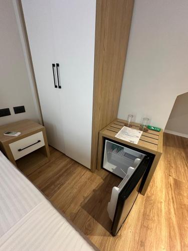 a room with a bed and a desk with a tv at Bel Ami Tirana 2 in Tirana