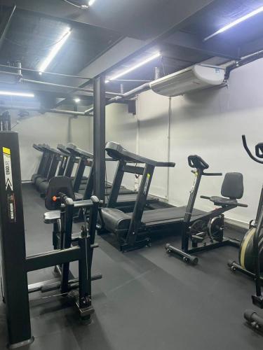 a gym with several tread machines in a room at Vem pro Copan in Sao Paulo