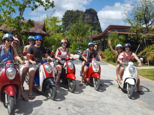 a group of people on scooters posing for a picture at Baannai Lake View Resort in Ao Nang Beach