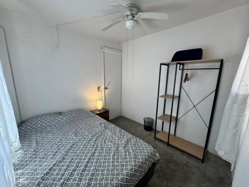a bedroom with a bed and a ceiling fan at Residencia en Guadalupe in Monterrey