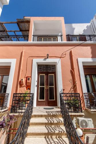 a staircase leading up to a building with a door at mascot traditional guest house in Rhodes Town