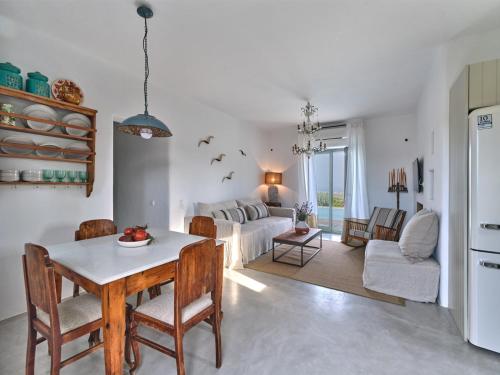 a living room with a table and a couch at Villa Joy with private pool, close to Naoussa in Kóstos