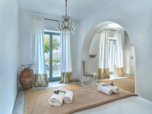 a room with a bed with towels on it at Villa Joy with private pool, close to Naoussa in Kóstos
