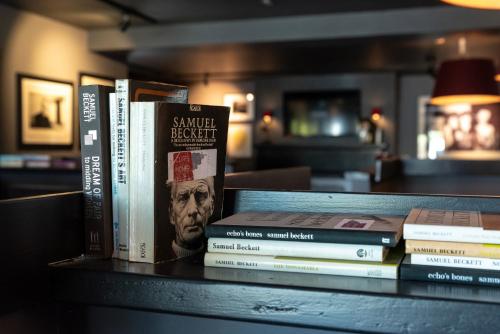 a group of books sitting on a table at Cliffs of Moher Hotel in Liscannor