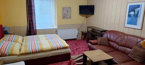 a living room with a couch and a table at penzion U Soudu in Liberec