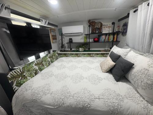 a bedroom with a large bed in a trailer at Unique Adventure Awaits in This Custom Tour Bus Conversion! in Clermont