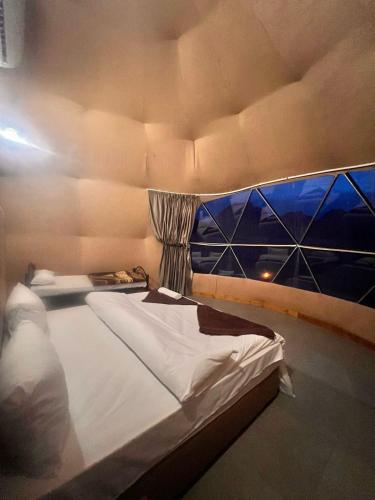 a large bed in a room with at Scarlet Luxury Camp Wadi Rum in Wadi Rum