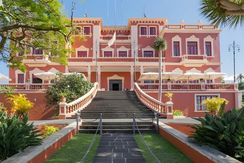 a pink building with stairs in front of it at Mojo Surf Yoga House in La Orotava