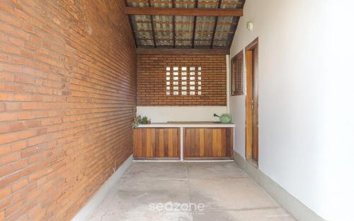 a brick wall with a counter in a hallway at Casa espaçosa c/lareira em Campos do Jordão RAS175 in Campos do Jordão