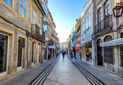 a city street with people walking down a street at Guest House Da Mata3 in Póvoa de Varzim