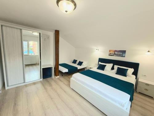 a bedroom with a large bed and a window at Vila Coty in Mamaia Nord