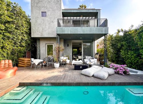 a house with a swimming pool in front of a house at Luxury Living in West Hollywood Modern 3BR Home w Pool & Hot tub in Los Angeles