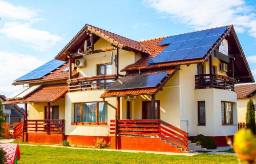 a house with solar panels on the roof at Pensiunea Nobila in Beclean