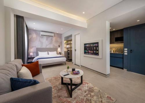a hotel room with a bed and a living room at 22 by spacey #54 Studio in Maadi in Cairo