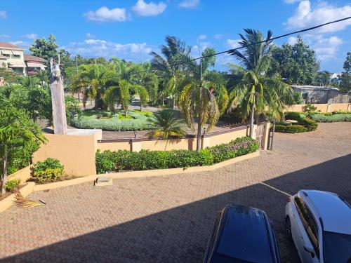a parking lot with palm trees and a street at palmview estate townhouse in Mammee Bay
