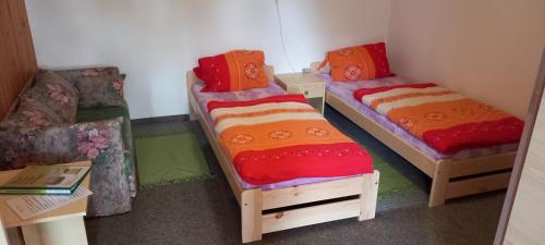a room with two bunk beds and a couch at Penzion U Dvou pánů in Pernink