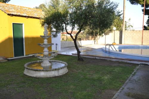 a fountain in a yard next to a playground at Casa Rural MATEOS in El Puerto de Santa María