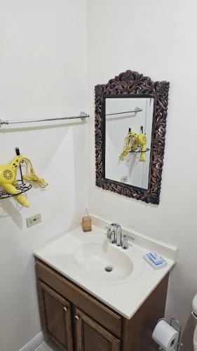 a bathroom with a sink and a mirror at palmview estate townhouse in Mammee Bay