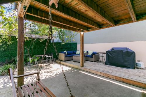 a porch swing with a hammock on a deck at 23 Center St - Sunny Side Down - Downstairs Apartment in Folly Beach