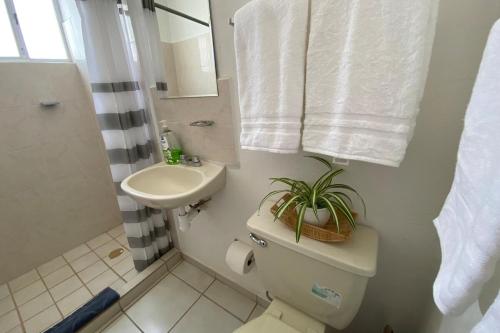 a bathroom with a toilet and a sink at Viaja y sientete comodo in León