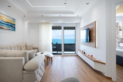 a living room with a couch and a bed at The Blue Pearl Apartment in Durrës