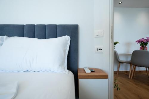 a bedroom with a bed and a table and a chair at The Blue Pearl Apartment in Durrës