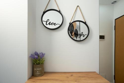 two mirrors hanging on a wall in a room at The Blue Pearl Apartment in Durrës