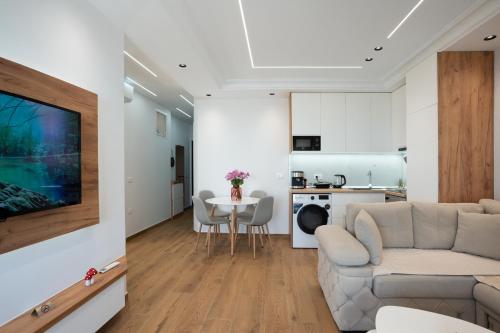 a living room with a couch and a table at The Blue Pearl Apartment in Durrës