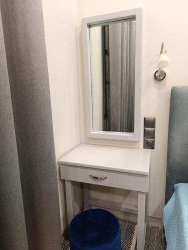 a bathroom with a white sink and a mirror at Irene' s Paradise in Skopelos Town