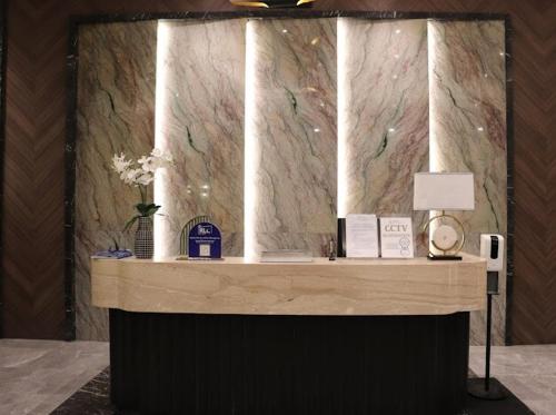 a counter in a room with a marble wall at RK Maisson Roiyale Aurora Escalades Cubao in Manila