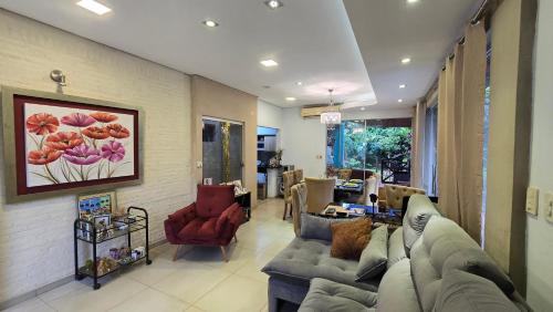 a living room with a couch and chairs in it at Ña Lucy in Fernando de la Mora