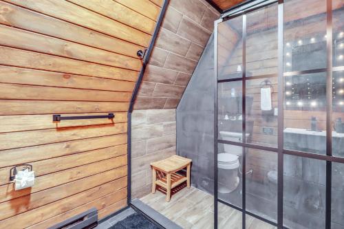 a small bathroom with wooden walls and a toilet at Hot Tub and Fire Pits Albrightsville A-Frame Cabin in Albrightsville