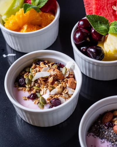 a group of bowls of food with nuts and fruit at Ola Santiago Providencia, Tapestry Collection by Hilton in Santiago