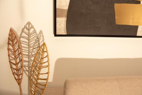 a couple of feathers sitting on top of a chair at Mia Anasa - Luxury Suites in Masouri