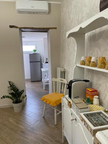 a kitchen with a stove top oven next to a table at Goti Rooms B&B in SantʼAgata deʼ Goti